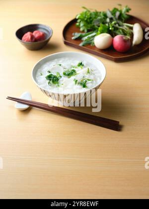 Reisbrei mit sieben Kräutern und eingelegten Pflaumen Stockfoto