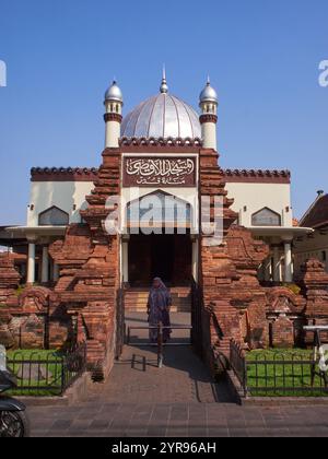 Vorderansicht der Moschee mit arabischer Kalligraphie, die ihren Namen aussagt: Al-Aqso-Moschee, Kudus-Turm. Akkulturation arabischer und hinduistischer Architektur Stockfoto