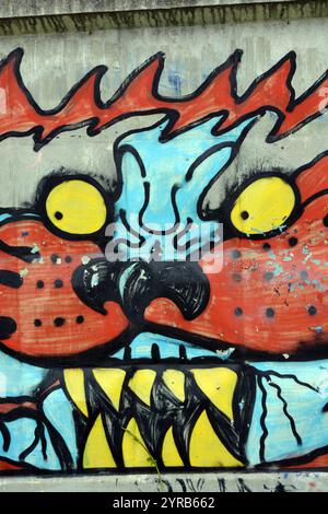 Wunderschöne, lebendige Zeichnungen und Tierbilder auf einer bräunlich-grauen Betonwand. Graffiti, ein großer Kopf, die Mündung eines Tigers mit Blau, Grau. Stockfoto