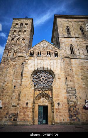 Die beeindruckende Fassade einer historischen Steinkirche in Osnabrück, Deutschland, mit zwei Türmen und komplexen architektonischen Details. Stockfoto