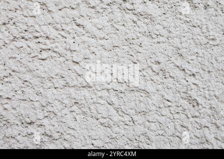 Grober grauer Putz an der Wand Nahaufnahme. Betonwand Hintergrund. Stockfoto