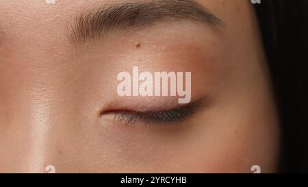 Extreme Nahaufnahme weibliche dunkle Augen Details Asiatische Frau Mädchen koreanisch chinesisch ethnisch gesunde japanische Dame Sehvermögen menschliche Auge Öffnung Iris Augapfel blinzeln Stockfoto