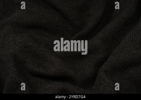 Dunkelgraue Pullover-Textur als Hintergrund. Strickmuster. Draufsicht. Stockfoto