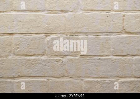 Weiße cremefarbene Backsteinhintergründe mit Strukturmustern, städtische Makroarchitektur Stockfoto
