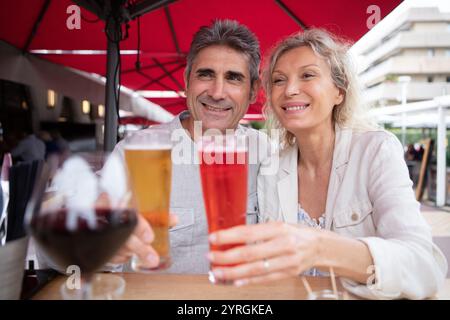 Glückliches Paar trinkt in einer Bar draußen Stockfoto
