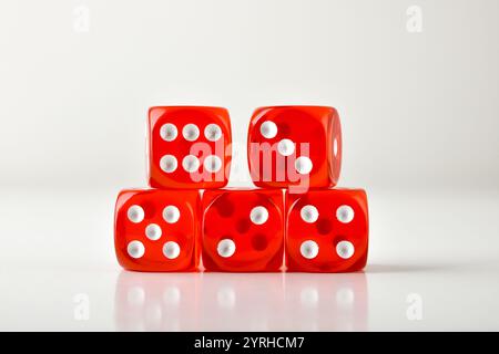 Set stack of transparent red gambling dice reflected on white table and white isolated background. Front view. Stockfoto