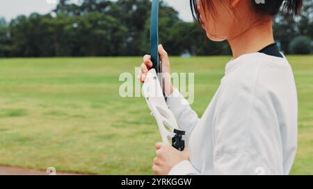 Mädchen, Bogen oder Hände des Bogenschützen für Sporttraining, Feld oder Vorbereitung auf Wettkampf, Ausrüstung oder Spiel. Bogenschießen, Sportler oder Schießstand in Stockfoto