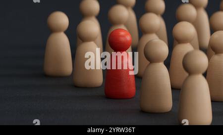 Rote Holzfigur, die in einer holzgelben Teamgruppe steht, um Einfluss und Ermächtigung zu zeigen. Business Leadership Team erfolgreich und Wettbewerb um Stockfoto