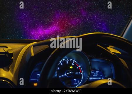 Blick auf das Universum mit Sternen durch die Windschutzscheibe eines fahrenden Autos Stockfoto