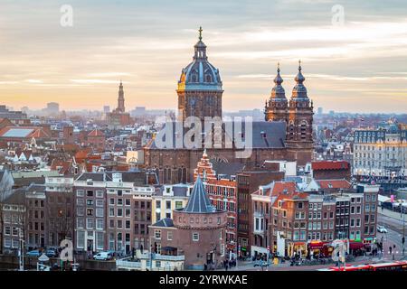 Gebäude der Skyline von Amsterdam während eines dramatischen goldenen Sonnenuntergangs. Foto am Abend in Amsterdam Niederlande Stockfoto