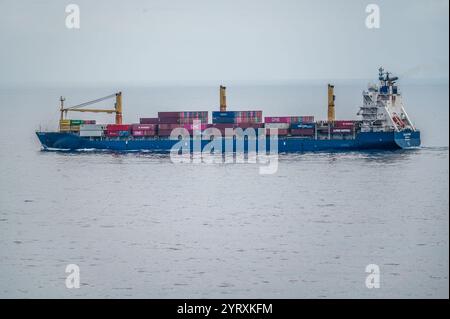 Dubai, VAE - 14. November 2024: Frachtschiff mit verschiedenen Containern auf offener See. Seefracht-Transportschiffe, die Güter weltweit befördern. M Stockfoto
