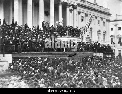 Präsident Abraham Lincolns zweite Amtseinführung im Jahr 1865, sein späterer Attentäter John Wilkes Booth (die Figur auf der Rückseite des Balkons ohne Hut), beobachtet, wie Lincoln seine Rede hält. Lincoln begann seine zweite Amtszeit am 4. März 1865 und hielt eine Antrittsrede auf den Stufen des Kapitolgebäudes in Washington D.C. Booth stand auf den Tribünen über dem Präsidenten zu beobachten. Lincoln bewunderte Booth für seine schauspielerischen Talente und der Schauspieler war mehrmals ins Weiße Haus eingeladen worden, ohne Erfolg. Lincoln hatte auch Booth in einem Stück im Ford's Theatre gesehen, das 1863 in derselben Lokation stattfand Stockfoto