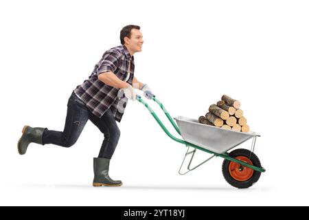 Mann, der mit Brennholz in einer Schubkarre läuft, isoliert auf weißem Hintergrund Stockfoto