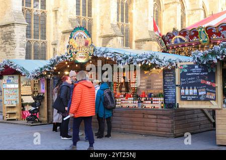 Ein Weihnachtsmarkt aus 600 Jahren ist zum ersten Mal seit 200 Jahren auf dem Gelände der Kathedrale von Canterbury mit Karussell und Chalets zurückgekehrt. Stockfoto