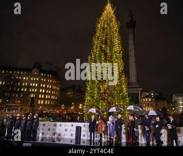 London, Großbritannien. Dezember 2024. Starker Regen fällt, wenn der Baum beleuchtet wird. Das jährliche Weihnachtsfest am Trafalgar Square wird von dem Bürgermeister von Westminster, dem Stadtrat Robert Rigby, begleitet von der Bürgermeisterin von Oslo, Anne Lindboe, dem Bürgermeister von London, Sadiq Khan und anderen VIPs. In einer langen Tradition ist der Baum ein Geschenk der Stadt Oslo, dieses Jahr eine 60 Jahre alte norwegische Fichte. In einer anderen offensichtlichen Tradition regnete es erneut stark für die Zeremonie. Quelle: Imageplotter/Alamy Live News Stockfoto