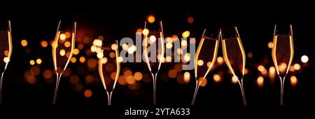 Cheers mit Champagner und goldenem Bokeh auf schwarzem Hintergrund. Horizontale Nahaufnahme für silvester und Hochzeit. Konzept für besondere Anlässe mit Platz für Text. Stockfoto