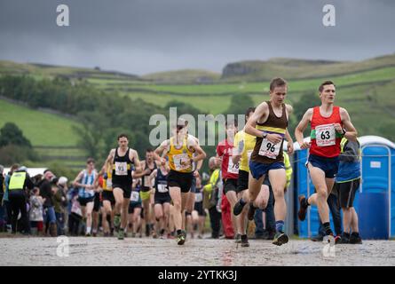 Läufer des Kilnsey Crag Fell Rennens, das bei der Kilnsey Show im Yorkshire Dales National Park, Großbritannien, ausgetragen wurde. Stockfoto