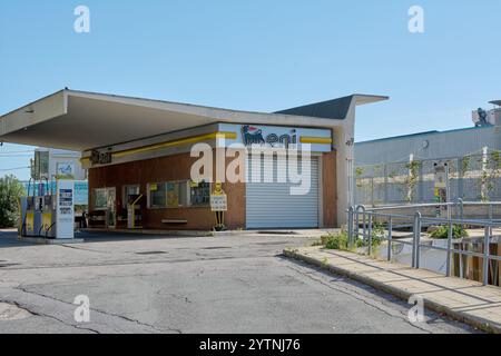 Savona. Italia - 07. Dezember 2024: Eine verlassene Tankstelle in Savona mit einem geschlossenen Geschäft und Vintage-Pumpen Stockfoto