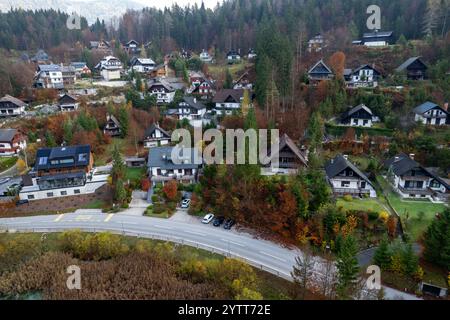 Bohinj-Tal, slowenien, mit farbenfrohem Herbstlaub und Häusern entlang einer gewundenen Straße Stockfoto