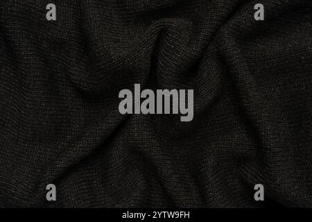 Dunkelgraue Pullover-Textur als Hintergrund. Strickmuster. Draufsicht. Stockfoto