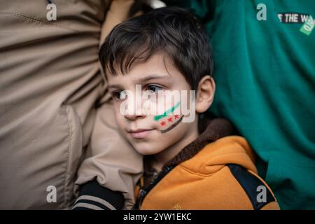 Istanbul, Türkei. Dezember 2024. Während der syrischen Feier zum Sturz des Assad-Regimes in Istanbul wird ein Kind mit den Farben der Oppositionsflagge auf seinem Gesicht gesehen. Quelle: SOPA Images Limited/Alamy Live News Stockfoto