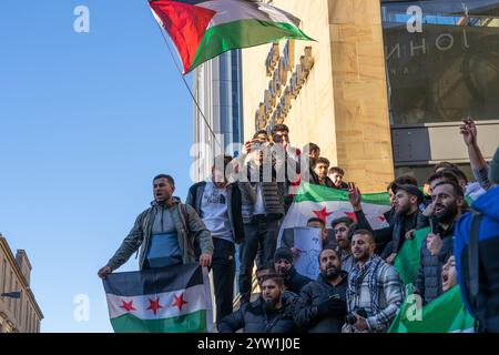 Glasgow, Schottland, Großbritannien. Dezember 2024. Eine Menschenmenge versammelt sich auf den Stufen der Buchanan-Straße, um den Fall der syrischen Regierung zu feiern, während Präsident Baschar al-Assad vor Rebellen flüchtet. Assad ist Präsident seit Juli 2000. Gutschrift R.. Gass/Alamy Live News Credit: Richard Gass/Alamy Live News Stockfoto
