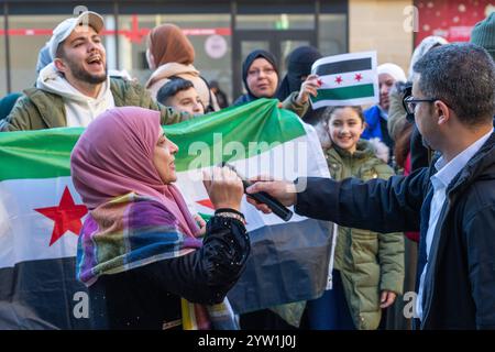 Glasgow, Schottland, Großbritannien. Dezember 2024. Eine Menschenmenge versammelt sich auf den Stufen der Buchanan-Straße, um den Fall der syrischen Regierung zu feiern, während Präsident Baschar al-Assad vor Rebellen flüchtet. Assad ist Präsident seit Juli 2000. Gutschrift R.. Gass/Alamy Live News Credit: Richard Gass/Alamy Live News Stockfoto
