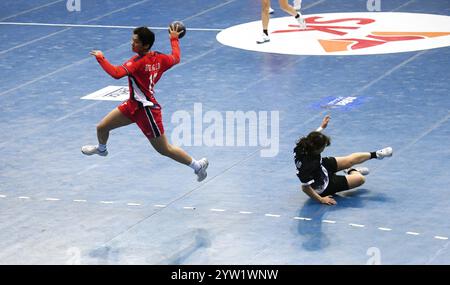 Neu-Delhi, Indien. Dezember 2024. Huang Zidie (L) aus China tritt während des Spiels zwischen China und Hongkong bei der Asiatischen Handball-Meisterschaft der Frauen in Neu-Delhi, Indien, am 8. Dezember 2024 an. Quelle: Str/Xinhua/Alamy Live News Stockfoto