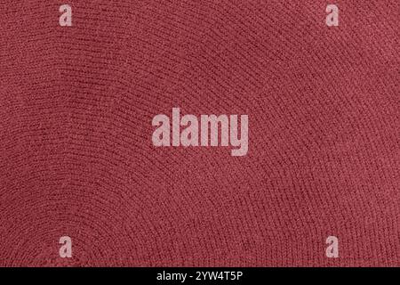 Kastanienbraunes Strickgewebe, Textur als Hintergrund, trendige Farbe Stockfoto