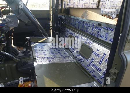 Schalldämmplatten werden in einem Land Rover Defender 110 der britischen Armee eingebaut Stockfoto