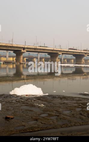 Straßenbrücke mit verschmutztem Fluss mit Industrie- und Haushaltsabwässern toxischer Schaum am Morgen wird am yamuna Fluss Okhla Staumauer delhi indien aufgenommen. Stockfoto