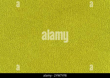 Abstraktes Textilmuster in gelber Farbe für Hintergrund. Nahaufnahme der Makrofotografie, Tischansicht von oben mit zitrusfarbenem, oberflächenebenem Material Stockfoto