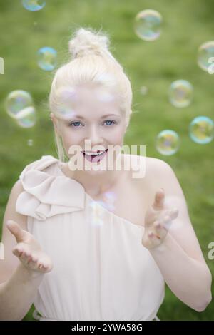 Junge, blonde Frau mit Seifenblasen Stockfoto