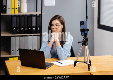 Videokonferenz Und Schulung. Klasse verschiedener Schüler, die per Fernzugriff online über die Web-App lernen. Lehrerin, die Unterricht mit Laptop, Aufnahme gibt Stockfoto