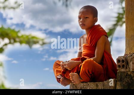 buddhistischer Anfänger, der auf der Mauer in Tonle SAP, Kambodscha sitzt Stockfoto