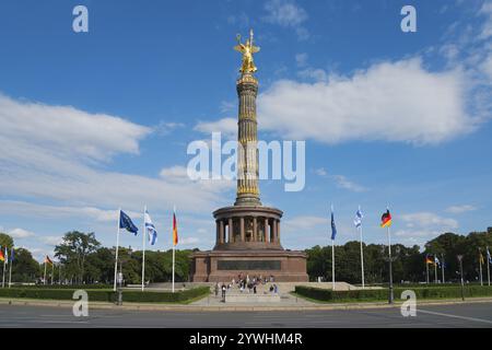 Die Berliner Siegessäule mit goldener Statue und internationalen Fahnen im Vordergrund, Siegessäule am Großen Stern, Berlin, Tiergarten distri Stockfoto