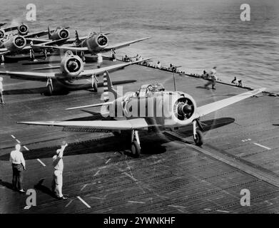 Douglas SBD Dauntlesses bereiten sich auf den Start vom Flugdeck vor, um den Angriff auf Wake Island im Nordpazifik durchzuführen. Von 1940 bis 1944 war das Flugzeug der wichtigste Trägerbomber der United States Navy und wurde auch vom United States Marine Corps geflogen, sowohl von Landflugplätzen als auch von Flugzeugträgern. Ein effektives Marineskupierflugzeug und Tauchbomber mit großer Reichweite, guten Handhabungseigenschaften, Manövrierbarkeit, starker Bombenlast und großartiger Tauchereigenschaften. Stockfoto