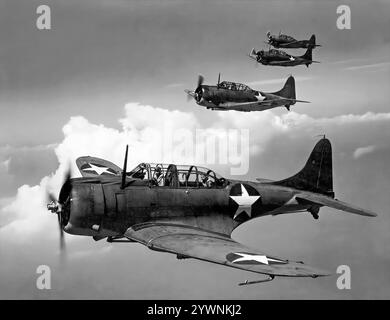 Eine Formation von Douglas SBD Dauntlesses. Von 1940 bis 1944 war das Flugzeug der wichtigste Trägerbomber der United States Navy und wurde auch vom United States Marine Corps geflogen, sowohl von Landflugplätzen als auch von Flugzeugträgern. Ein effektives Marineskupierflugzeug und Tauchbomber mit großer Reichweite, guten Handlingeigenschaften, Manövrierbarkeit, starker Bombenlast und großartigen Taucheigenschaften, ist es am besten als der Bomber zu erinnern, der den japanischen Trägern bei der Schlacht von Midway im Juni 1942 die tödlichen Schläge lieferte. Stockfoto