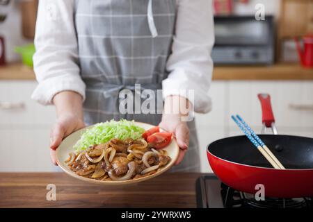 Frau, die einen Teller mit Schweinekekekuchen hält Stockfoto