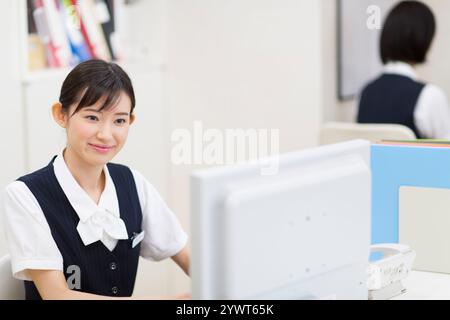 Frau in Uniform, die Computer spielt Stockfoto