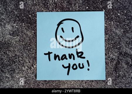 Vielen Dank, die Sie auf einen Post-it oder eine Notiz geschrieben haben. Stockfoto