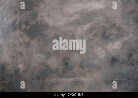 Abstrakte strukturierte graue Wand mit wirbelnden Mustern. Stockfoto