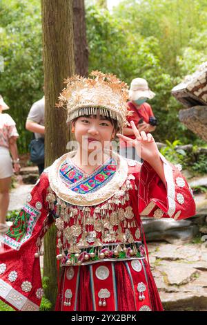 GUIZHOU, GUIYANG, CHINA, 16. AUGUST 2022: Ein Mädchen in traditioneller Miao-Kleidung im Yelang-Tal, einem magischen Ort voller Steinburgen, Turm Stockfoto