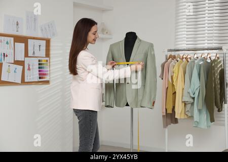 Modedesignerin bei der Messung von Jacke in der Werkstatt Stockfoto