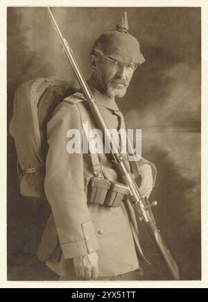 Soldat in Uniform 1. Weltkrieg, 1914. Zusätzliche Info: Ein Atelierporträt eines deutschen Soldaten in Uniform des Ersten Weltkriegs mit Brandenburger Handschellen und Pickelhaube. Er hält ein Bajonettgewehr über der Schulter und hat einen Rucksack auf dem Rücken. Stockfoto