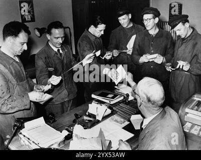 Arbeiter der Hamburger Gaswerke erhalten ihren Lohn in Bargeld in Umschlägen in Hamburg Wandsbek. [Automatisierte Übersetzung] Stockfoto