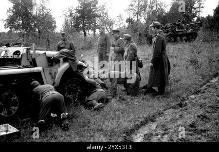 Russland 1943 defektes Halbspurfahrzeug mit deutschem General und Begleitservice. Im Hintergrund ein Marder-III-Panzerzerstörer mit berittener Infanterie. Das Foto wurde während der russischen Offensive (Smolensk-Operation) im zentralen Abschnitt der Ostfront aufgenommen. [Automatisierte Übersetzung] Stockfoto