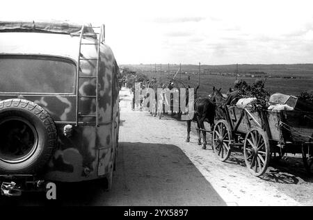 Russland, Juli 1944: Moskauer-Minsk-Landebahn, deutscher Rückzug, Soldaten auf Pferdefahrzeugen mit LKW während der russischen Sommeroffensive (Operation Bagration), die zum Zusammenbruch des deutschen Heeresgruppenzentrums führte. Der Bus ist ein Fahrzeug des Personals der 110. Infanteriedivision, zu der der Fotograf gehört. [Automatisierte Übersetzung] Stockfoto