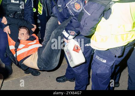Mehrere Stunden Blockade einer der wichtigsten Straßen Warschaus durch die letzte Generation. Die Polizei bringt eine Person weg, die die Straße blockiert. Einer der Beamten hält eine Dose Aceton in der Hand, mit der der Aktivist vom Asphalt gelöst wurde. Warschau Polen Copyright: XMikolajxJaneczekx Stockfoto