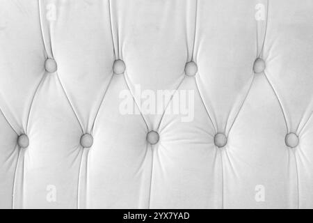 Capitone, rautenkarierter weicher Textilinhalt mit Knöpfen. Klassischer Chesterfield-Retro-Stil, luxuriöse Polsterung in weißem Textu Stockfoto